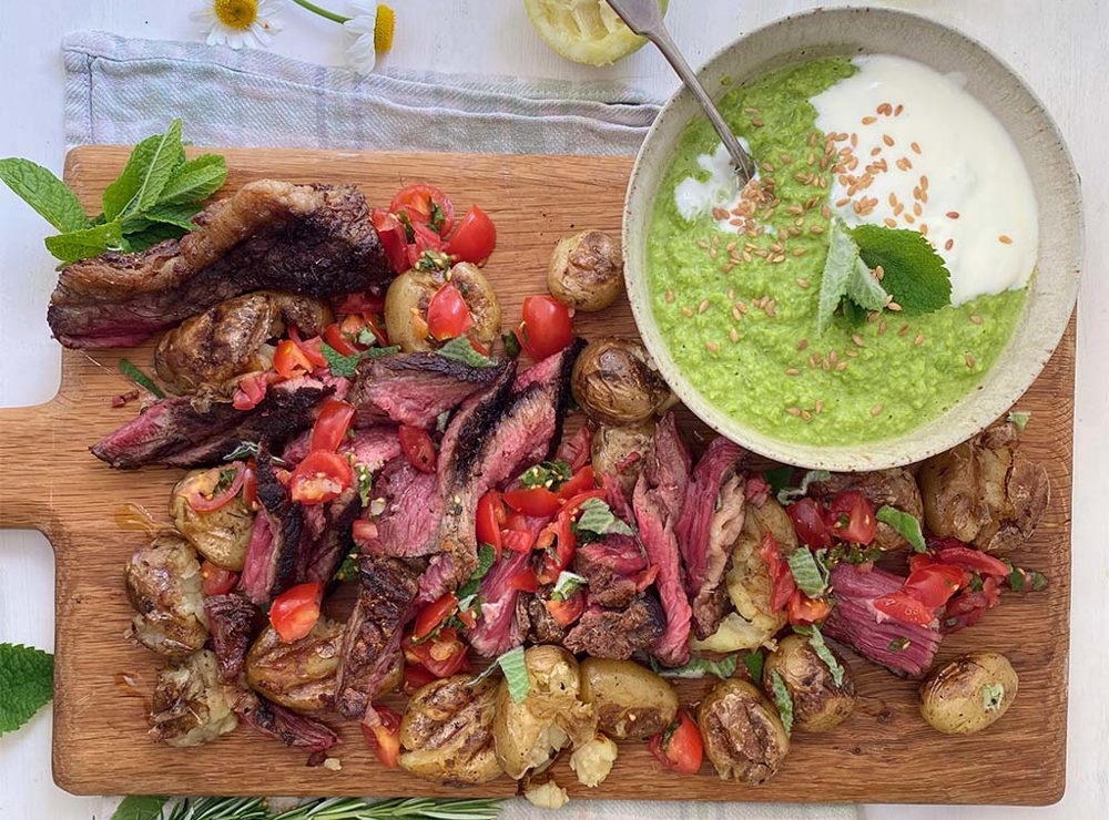 Barbecued steak with smashed rosemary potatoes and pea guacamole