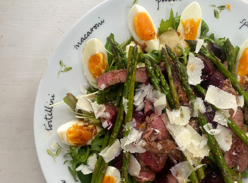 Summery beef salad with beetroot, rocket and eggs, new potatoes and asparagus